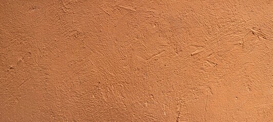 Panorama of The exterior cement wall of the building is painted brown with a rough surface texture and background seamless