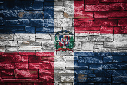 National flag of Dominicana on stone  wall background.The concept of national pride and symbol of the country. Flag  banner on  stone texture background.