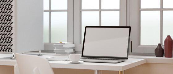 Mock-up laptop on white table beside the window in white concept office room, 3D rendering