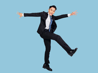Excited young  businessman jumping and dancing