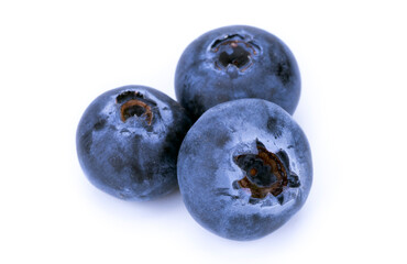 Three whole blueberries on a white background, isolated