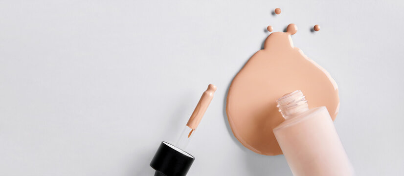 Banner with Mockup glass bottle of correction cosmetic product with pipette. Spilled Liquid foundation. Beauty branding concept
