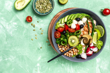 Buddha bowl dish with chicken fillet, asparagus, chickpeas, broccoli, radish, cucumber, avocado, tomatoes, mozzarella. Detox and healthy superfoods bowl concept, top view, flat lay