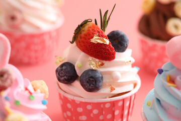 Colorful cupcakes isolated in pink background