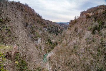 spring sunny panoramic view of the mountains and the river from the bridge in park. Sochi, Russia