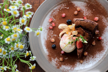 Chocolate cake with ice cream dessert on wood table
