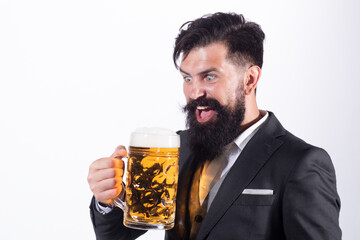 Funny excited man in classical suit holding glass with beer in hand. Smiling man with beer. Bartender, happy brewer.