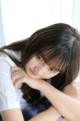 Portrait japanese school girl uniform in white tone bed room