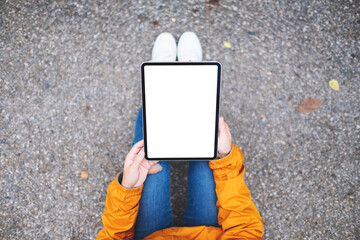 Top view mockup image of a woman holding digital tablet with blank white desktop screen in the outdoors