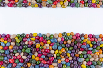 Fototapeta na wymiar Colorful background of colorful round candy drops. Assorted bright candy balls or dragees. Color background. Copy space