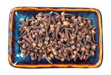 top view of dried cloves in ceramic bowl cutout
