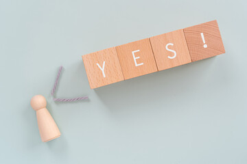 賛成、イエス｜「YES!」と書かれた積み木と人型のオブジェ