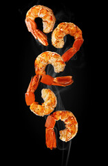 Grilled shrimp tails hovering in white haze on black background