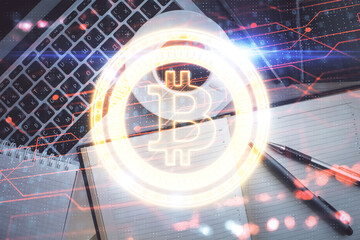 Blockchain theme hologram drawings over computer on the desktop background. Top view. Double...