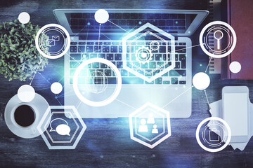 Obraz premium Social network hologram drawings over computer on the desktop background. Top view. Double exposure.