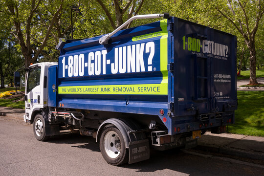Tigard, OR, USA - May 2, 2021: A 1-800-GOT-JUNK branded vehicle is seen parked on the streets in Tigard, Oregon. Rubbish Boys Disposal Service (RBDS) Inc. is a Canadian franchised junk removal company