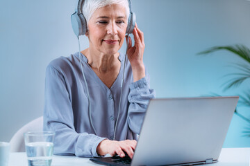 Senior Woman Doing Audiogram Hearing Test at Home, using Laptop