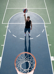 Basketball street player with basketball ball outdoor. Hand spinning basket ball. Balancing...