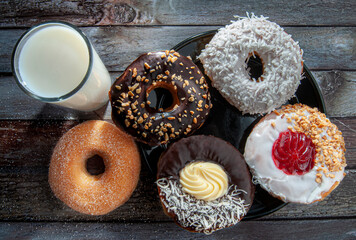 donuts and a glass of milk on the table, doughnuts as dessert, and snack concepts