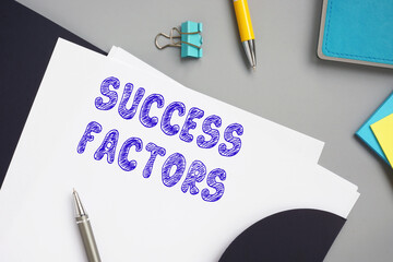 Business concept meaning SUCCESS FACTORS with phrase on the sheet.