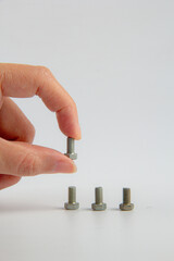 Hand and metal bolt isolated on white background
