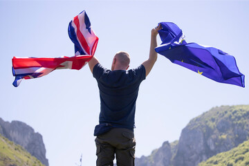 UK England Flag and European Union EU Flag holded by a man.