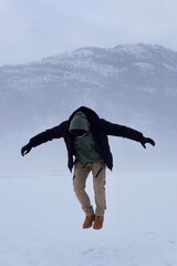 person jumping in the snow