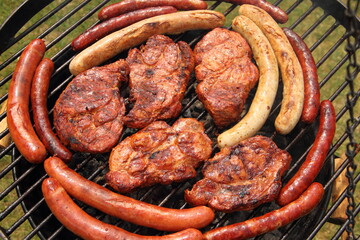 various meat and sausages on the charcoal grill