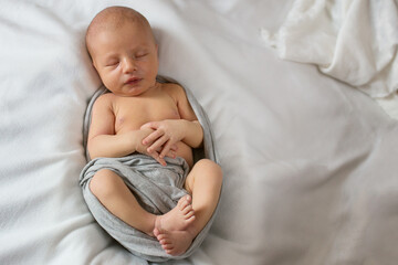Beautiful newborn baby is beautiful poses and sleeps - obrazy, fototapety, plakaty