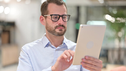 Portrait of Businessman using Digital Tablet