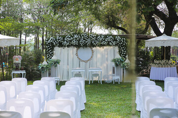Garden wedding, wedding backdrop And many chairs arranged in the garden