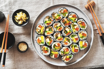 vegan sushi with tofu and avocado on a plate on a linen napkin.