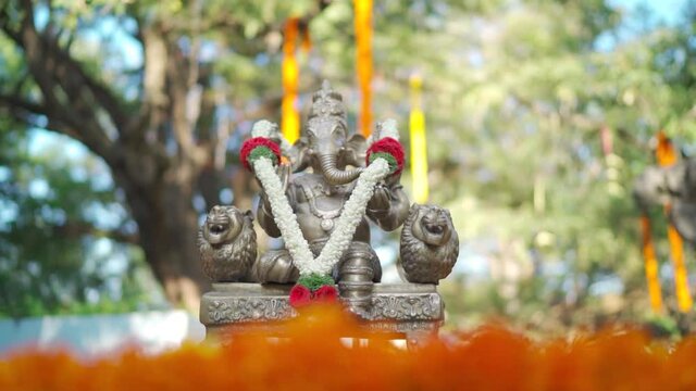 Close up Shot of Lord Ganesha with beautiful garland in daylight.