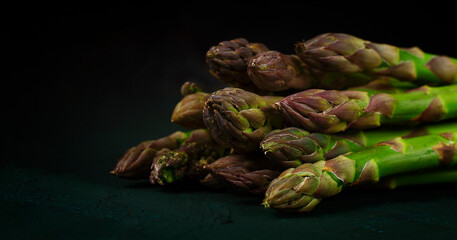 Bouquet of fresh asparagus, horizontal, on a dark background, no people,