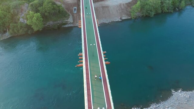 Footbridge: bridge for pedestrians and cyclists - overpass walkway with bike lanes. Steel bridge over canal as separation structure in sustainable transport system. Falsework scaffolding support.