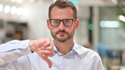 Portrait of Disappointed Businessman doing Thumbs Down