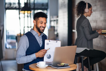 Business people with laptop working in cafe, freelance work and video call concept.