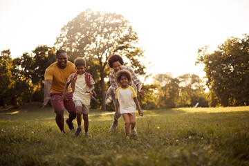  African American family having fun outdoors. - Powered by Adobe