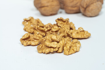 walnut kernels and whole nuts on a light background. shallow depth of field