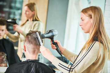 Haircut of young man. Hairdressing at barber shop