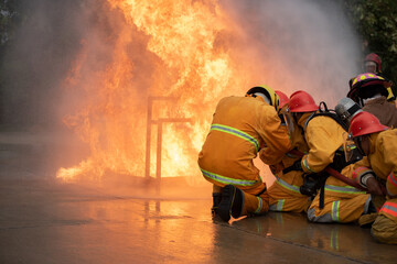 Practice extinguishing the fire Firefighter are using water in fire fighting operationFiremen...