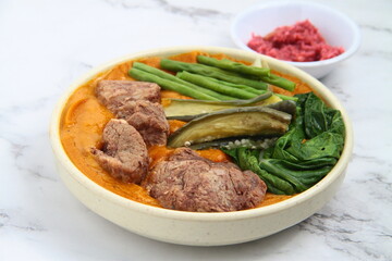 Filipino food called Kare Kare or meat and vegetables cooked in savory thick peanut sauce