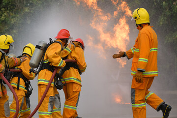 Practice extinguishing the fire Firefighter are using water in fire fighting operationFiremen...