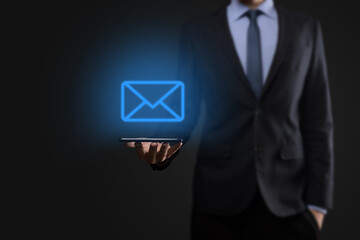 Businessman hand holding e-mail icon, Contact us by newsletter email and protect your personal information from spam mail. Customer service call center contact us concept