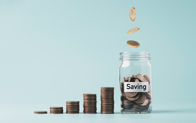 Coins falling and dropping to jar bank saving beside of growth coins stacking on blue background...
