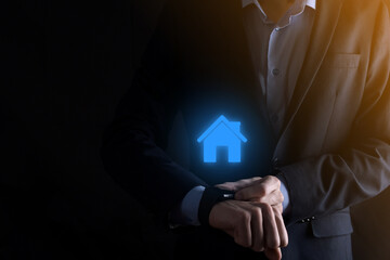 Real estate concept, businessman holding a house icon.House on Hand.Property insurance and security concept. Protecting gesture of man and symbol of house.