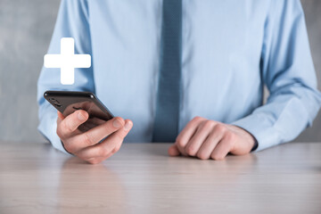 Businessman, man hold in hand offer positive thing such as profit, benefits, development, CSR represented by plus sign.The hand shows the plus sign