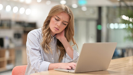 Tired Businesswoman with Laptop having Neck Pain in Office