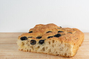 Italian focaccia genovese with black olives. Traditional and delicious Italian salty food.