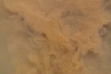 Abstract brown background, pattern. Muddy water, dirty river flow.